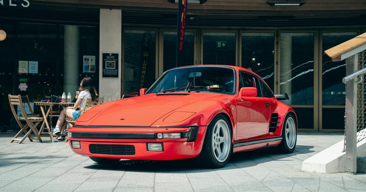 Classic red sports car parked outdoors in Southampton, England with a cafe in the background.
