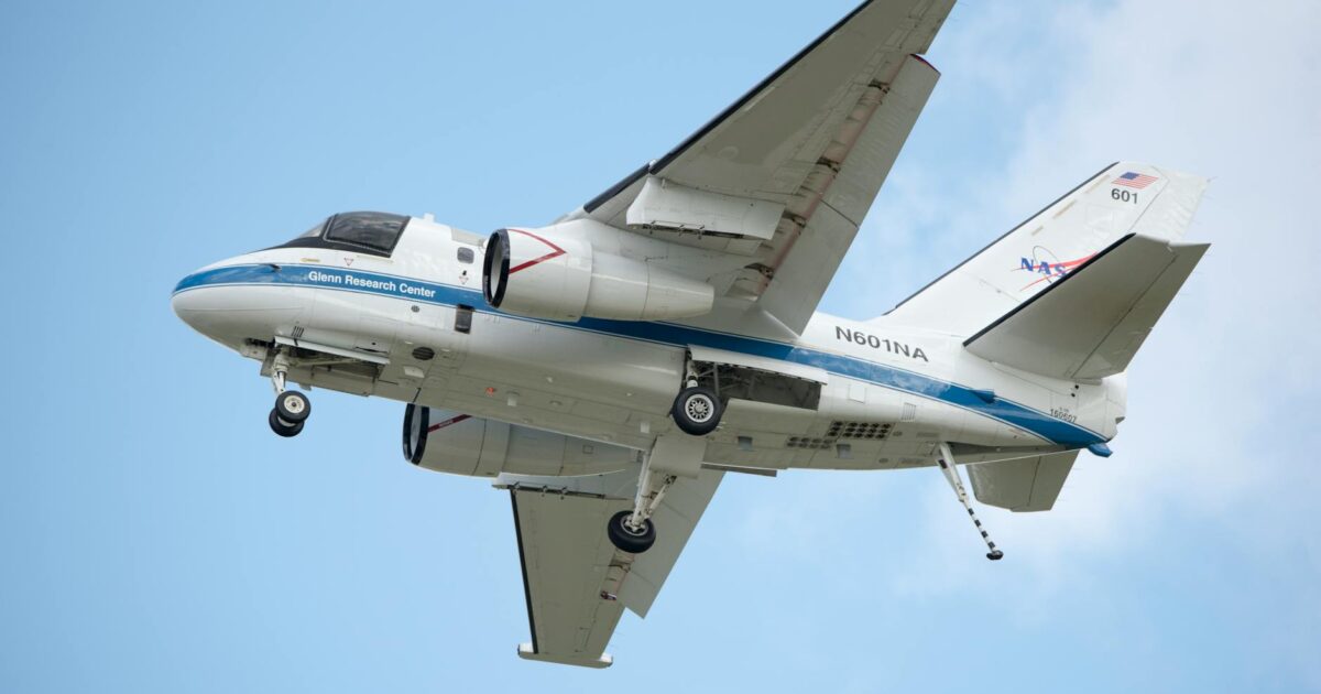 NASA aircraft in flight showcasing engineering marvel against a clear blue sky.